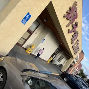 two cars parked in front of the store