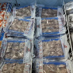 a display of frozen meat in plastic bags