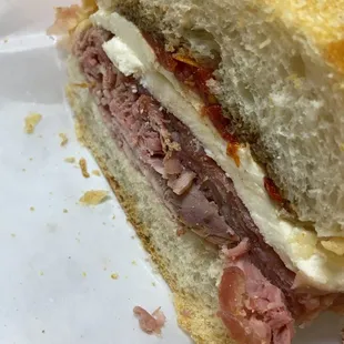 a sandwich with meat and cheese