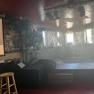 a room with a bed, a desk and a projector screen