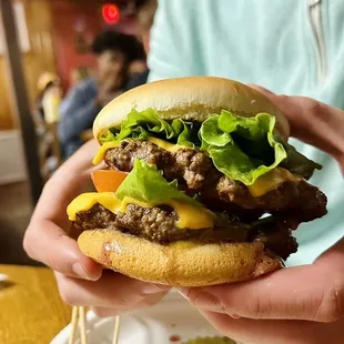 a man holding a hamburger