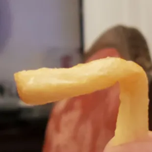 a hand holding a piece of food