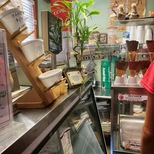 Cramped front counter between cooler and drinks.