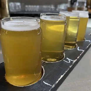 a row of beer glasses on a bar