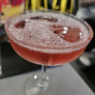 a pink drink in a coupe glass