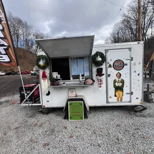  white food truck with a green door