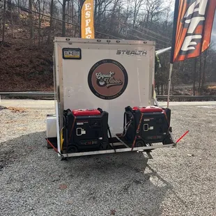  trailer with two generators attached to it
