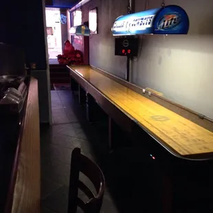 a shuffler table and a neon sign