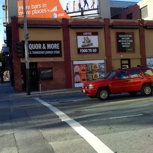 a red car driving down the street