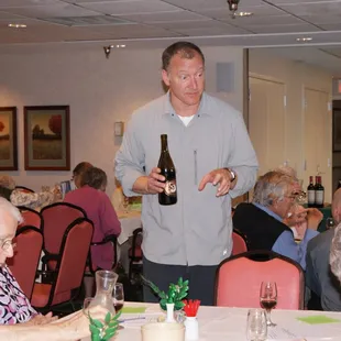 a man holding a bottle of wine