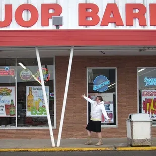 a man standing in front of a liquor barrel