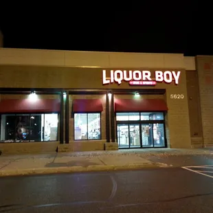 the front of a liquor shop at night