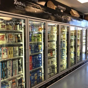 a row of beer coolers in a store