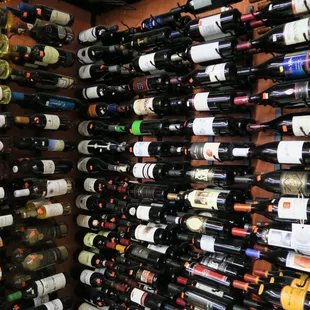 a wall of wine bottles in a store