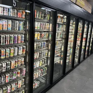 a row of beer coolers in a store