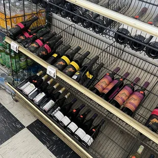 bottles of wine on shelves in a grocery store