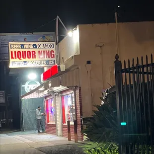 the front of a liquor shop at night