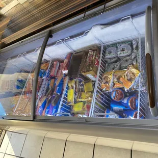 a refrigerator full of drinks and snacks