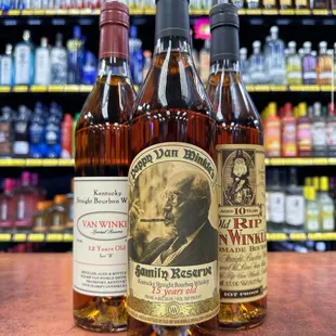 three bottles of wine on a counter