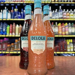 three bottles of deloloa soda on a counter