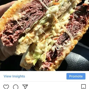 a person holding a sandwich