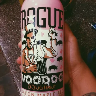 a hand holding a bottle of liquor