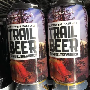 two cans of trail beer in a cooler