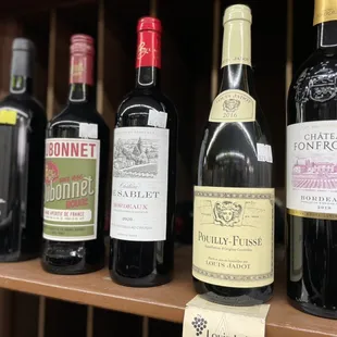 a row of wine bottles on a shelf