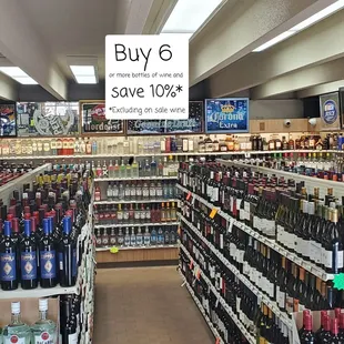 a large selection of wine in a store