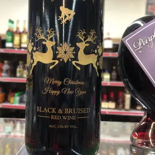 a bottle of black and red wine