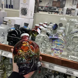 a hand holding a bottle of liquor