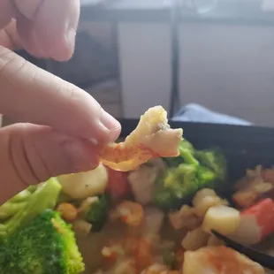 a hand holding a piece of food