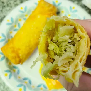 a hand holding a piece of food