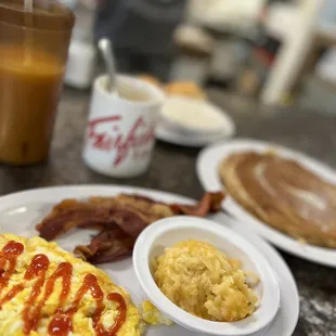 a breakfast of eggs, bacon, hash browns, and coffee