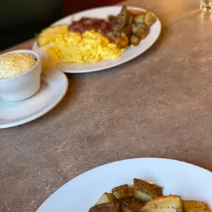 a plate of eggs, potatoes, and hash browns