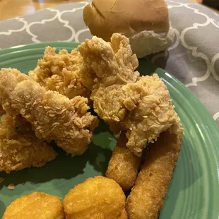 a plate of fried chicken and tater tots
