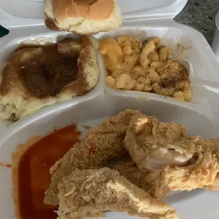 Fried chicken tenders, mashed potatoes, Mac and cheese and a roll. We had to season our food. Still tastes terrible.