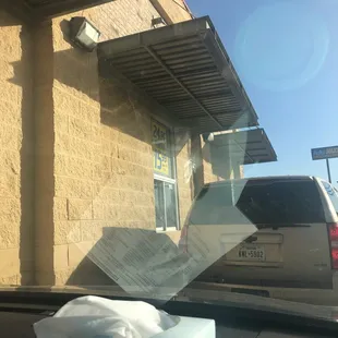 a broken tv outside of a restaurant