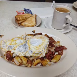 a breakfast of eggs, potatoes and toast