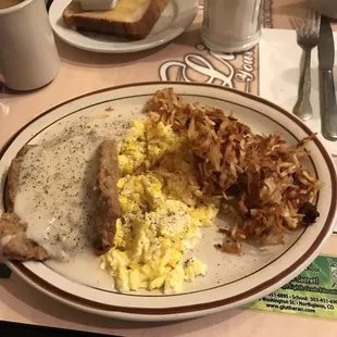 Chicken Fried Steak with scrambled eggs and extra crispy hash browns on request