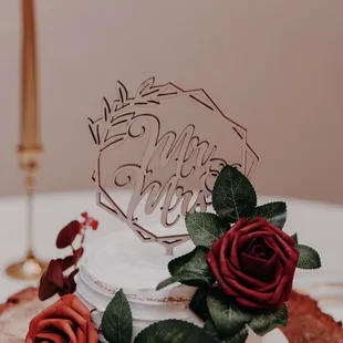 a wedding cake with red roses