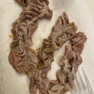 a piece of meat on a napkin with a fork