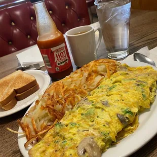 Vegetarian omelette with hashbrowns and toast.