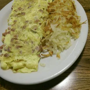 Corn beef and swiss omlet with hash browns.