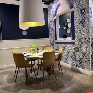 a dining room with blue and white wallpaper