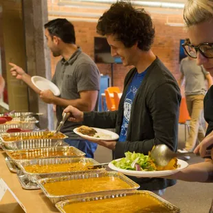 a group of people at a buffet line