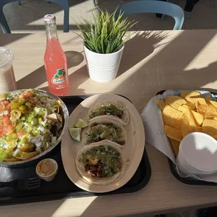 Nachos, al pastor tacos, cups and queso  Horchata and jarritos