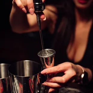 a bartender pouring a drink
