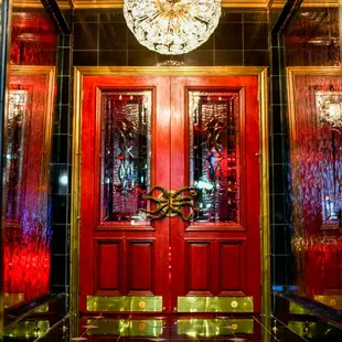a red door and chandelier