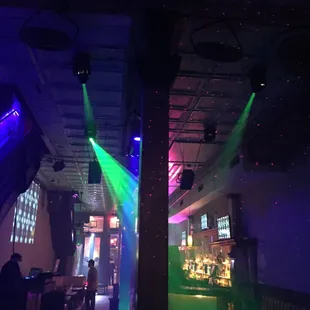 a disco scene with green and purple lights